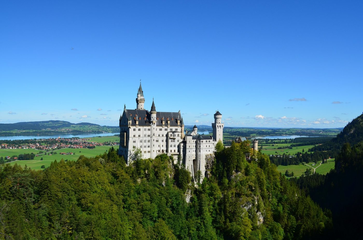 Neuschwanstein Castle above the Alpine foothills and lakes